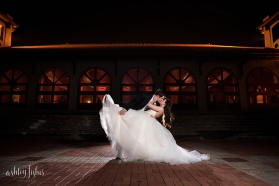Photo of groom dipping the bride at night at a wedding at the World's Fair Pavilion in Forest Park.