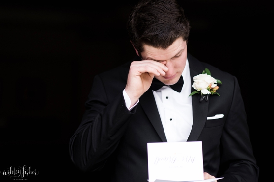 Photo of groom crying while reading love note from bride