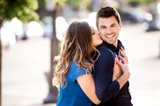 Photo of woman kissing mans cheek in Clayton park for engagement session