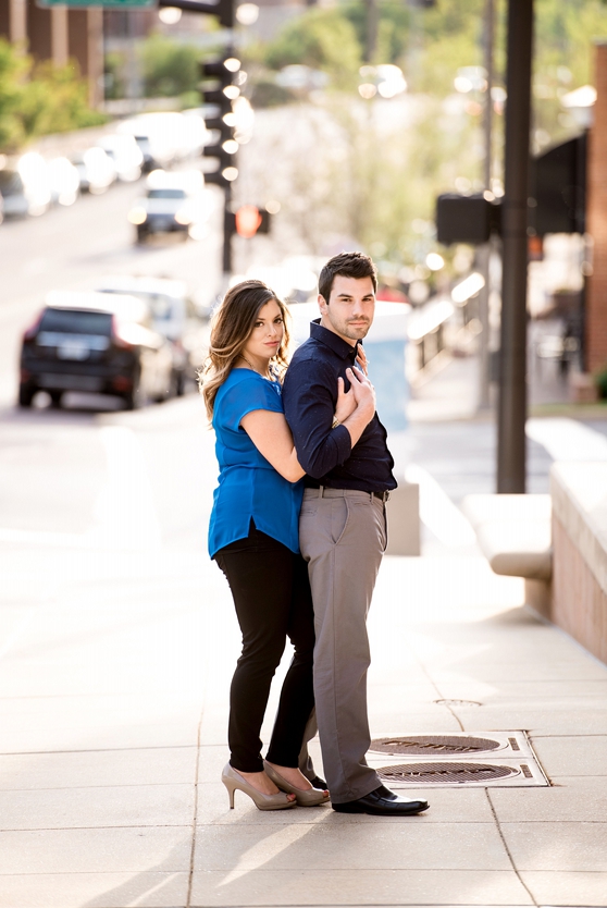 Photo of couple standing close together on street in Downtown Clayton engagement session