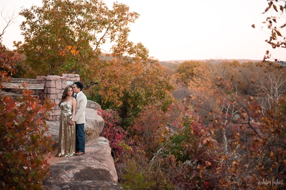 Photo of couple on rock cliff surrounded by fall trees at Johnson Shut Ins