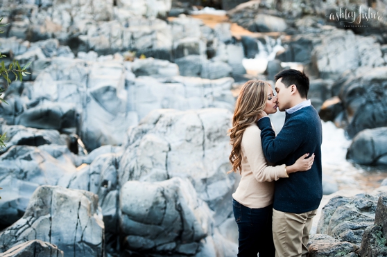 Photo of kissing couple on the rocks at Johnson Shut Ins engagement session