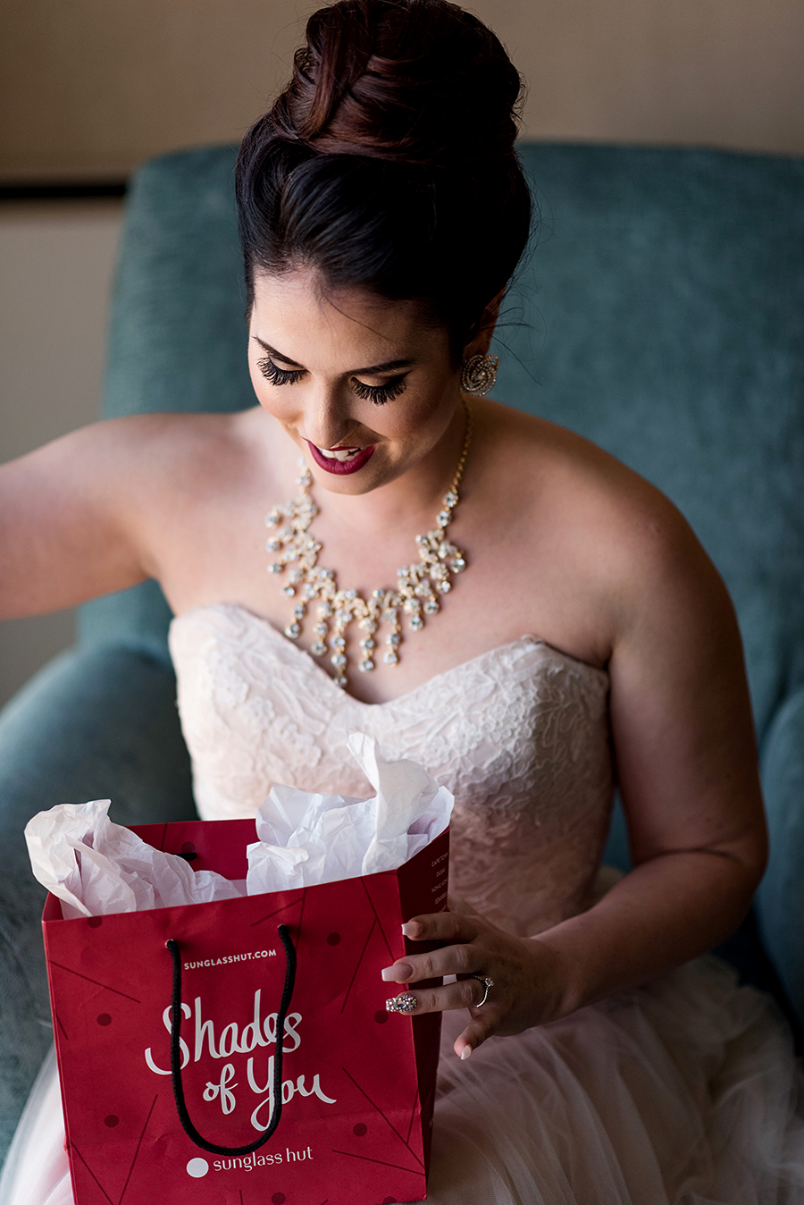 bride opening wedding gift at pear tree inn by ashley fisher photography
