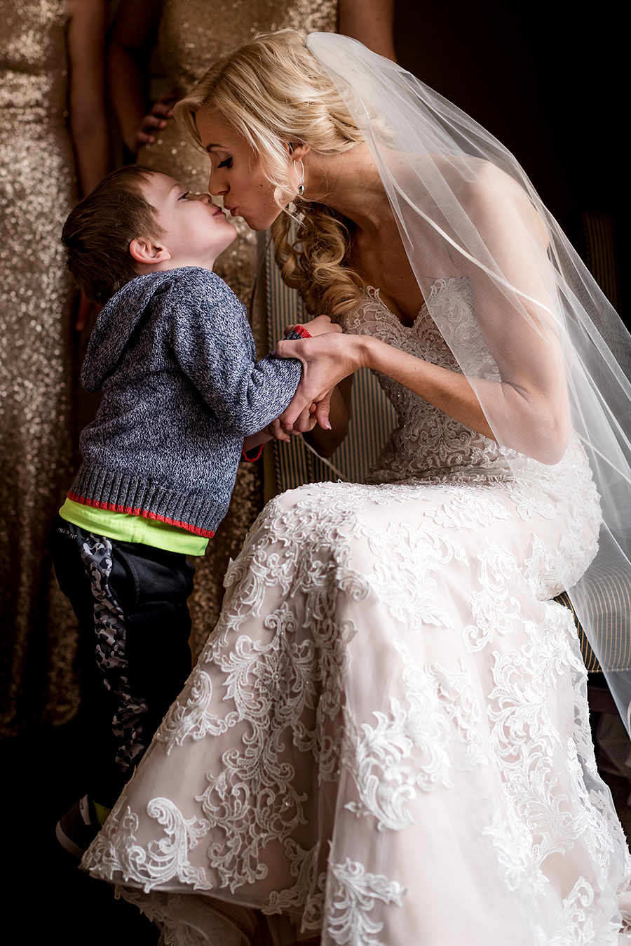 ringbearer giving the bride a kiss for a winter wedding at graham chapel by ashley fisher photography