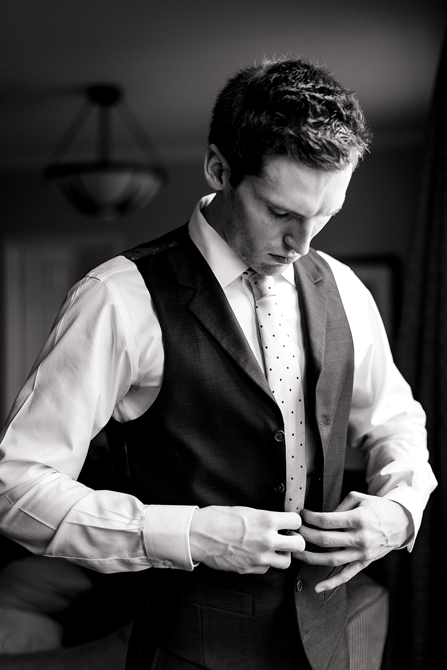 groom getting ready at the chase park plaza for a winter wedding at graham chapel by ashley fisher photography