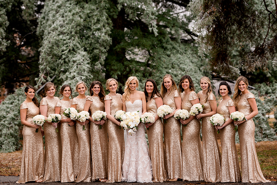 bridesmaids in gold sequin gowns during ice storm for a winter wedding at graham chapel by ashley fisher photography