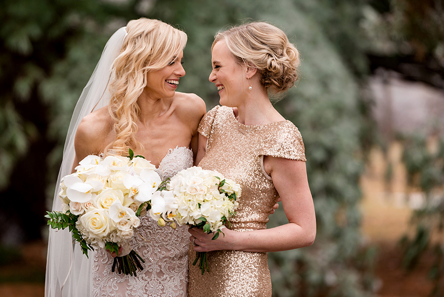 bridesmaid and maid of honor laughing for a winter wedding at graham chapel by ashley fisher photography
