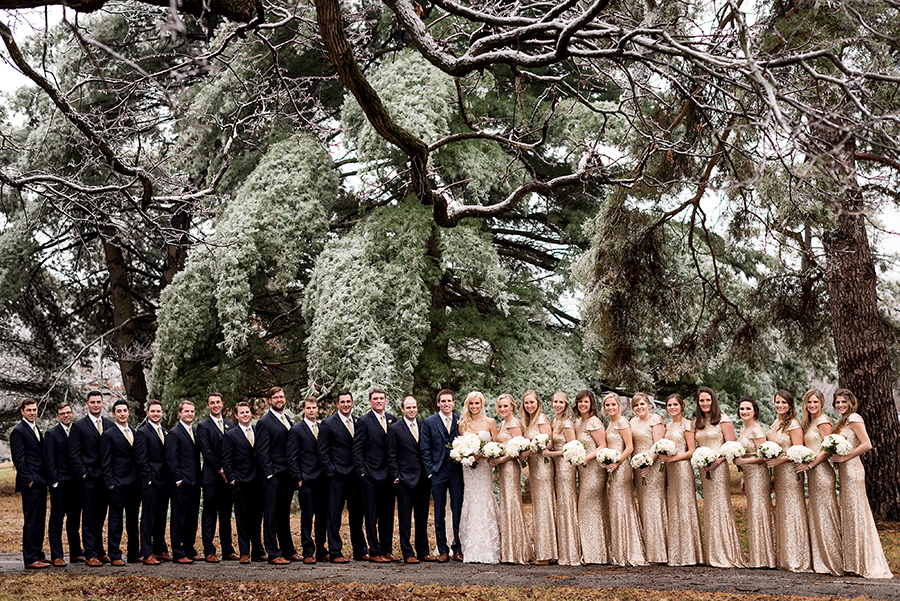 wedding party with navy suits and gold sequin dresses during ice storm for a winter wedding at graham chapel by ashley fisher photography