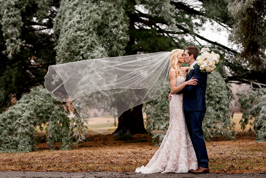 bride and groom veil toss for a winter wedding at graham chapel by ashley fisher photography