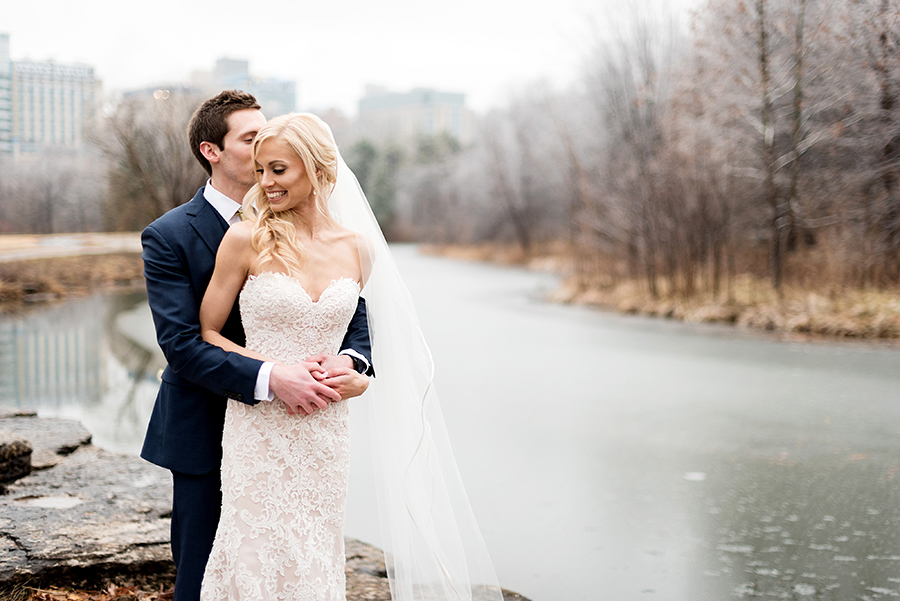 bride and groom on a frozen river for a winter wedding at graham chapel by ashley fisher photography
