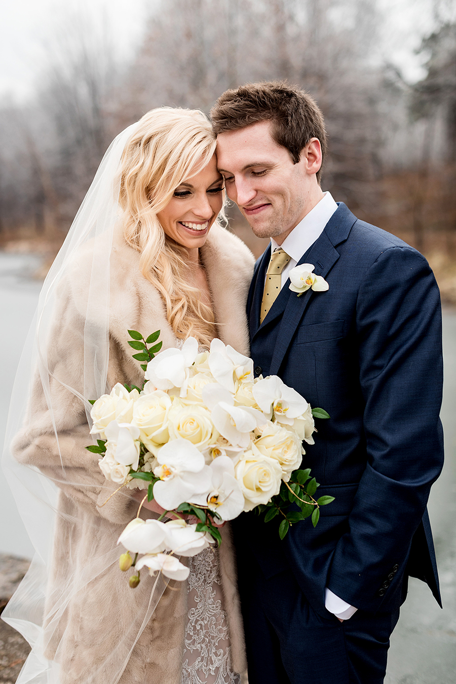 bride wearing vintage fur coat for a winter wedding at graham chapel by ashley fisher photography