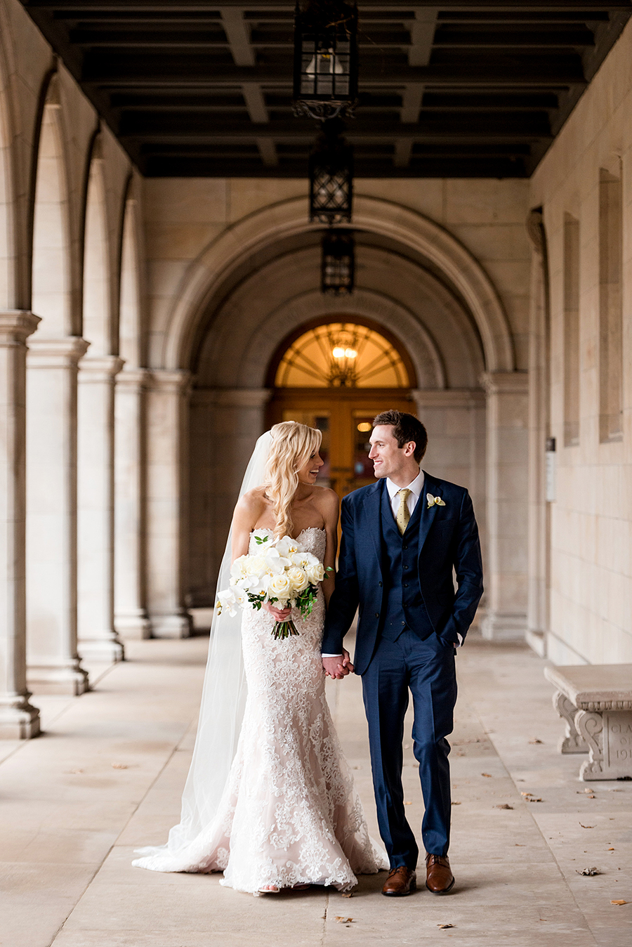bride and groom walk at washington university for a winter wedding at graham chapel by ashley fisher photography