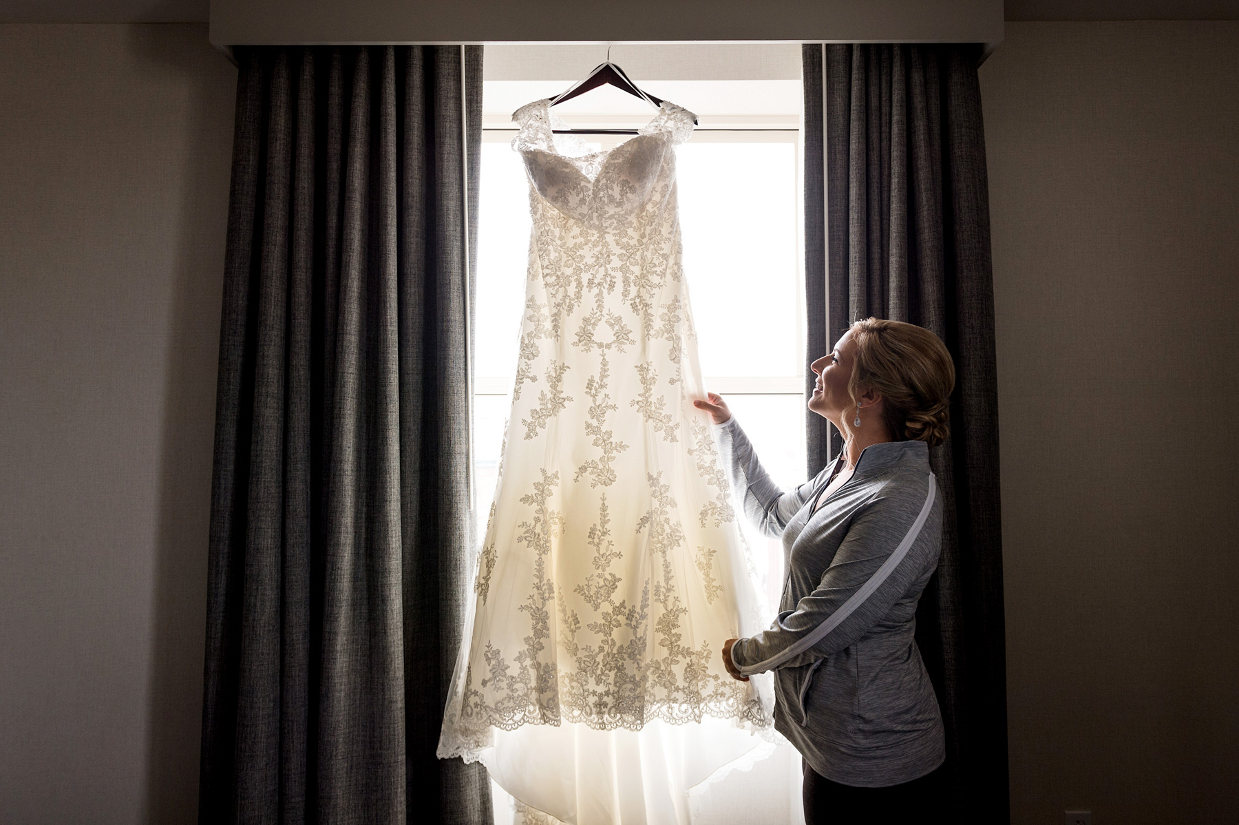 photo of bride admiring her dress by ashley fisher photography