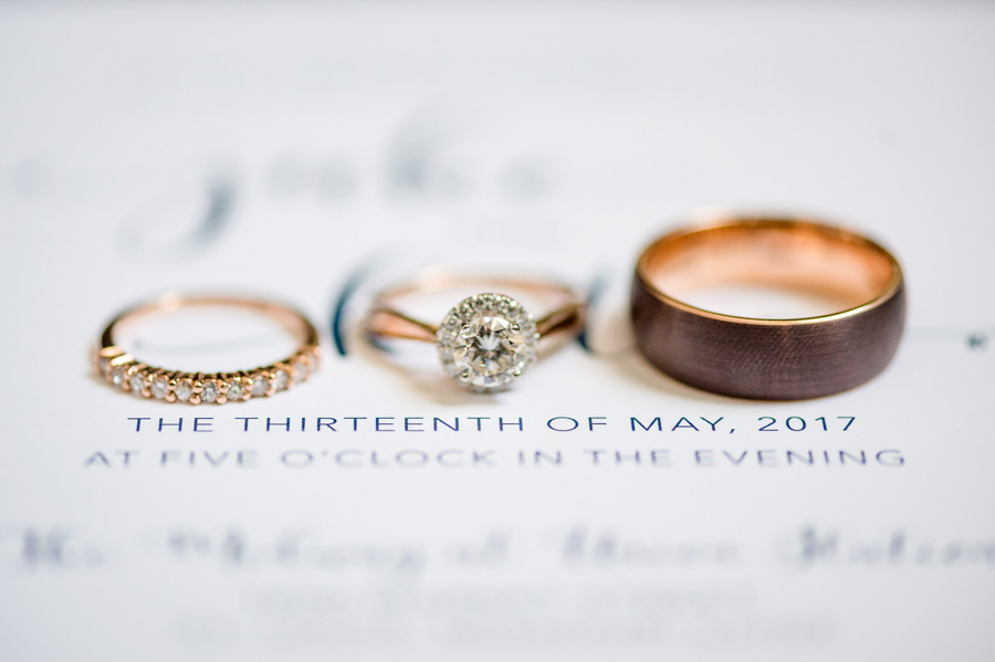 photos of rings on wedding invitation suite by ashley fisher photography