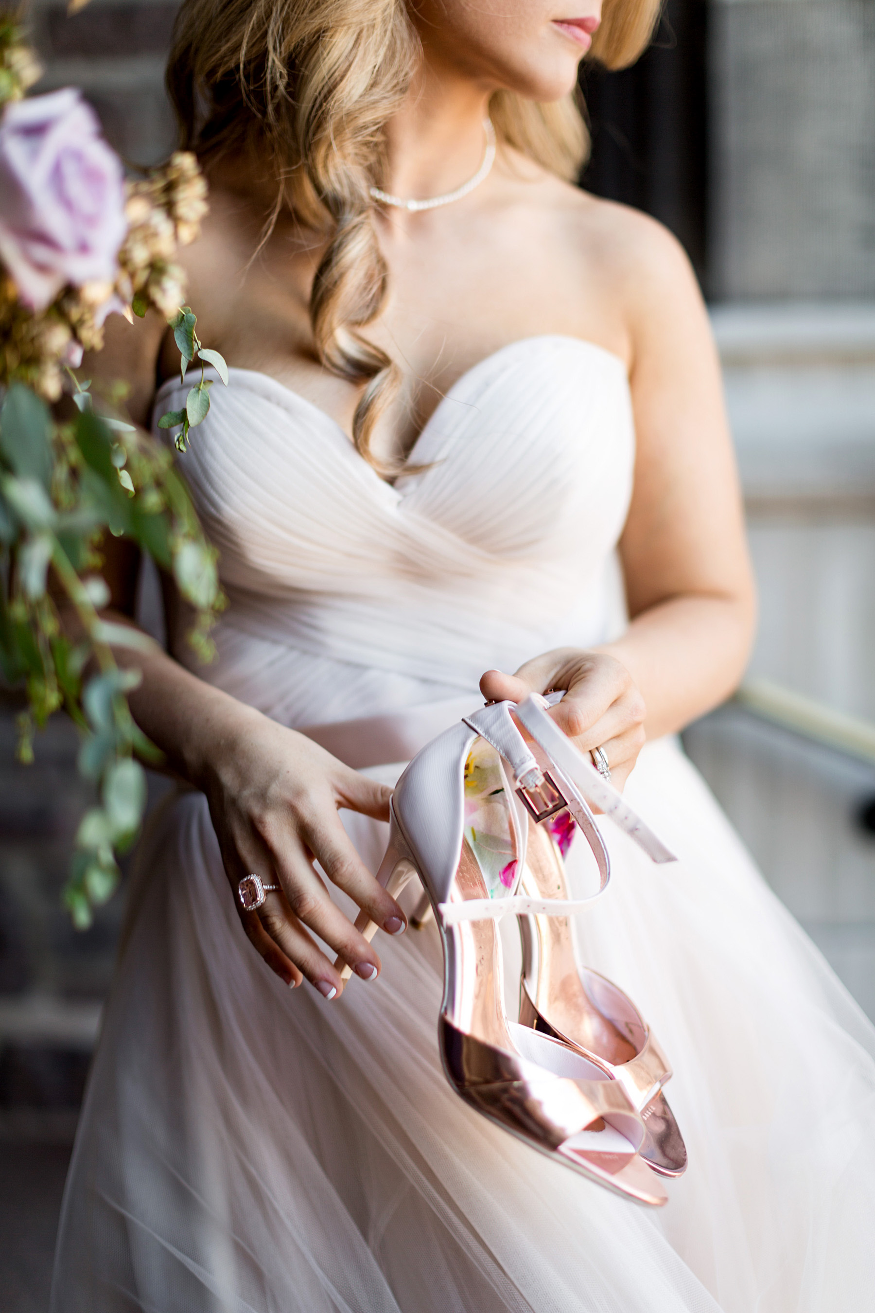 bride holding shoes by ashley fisher photography