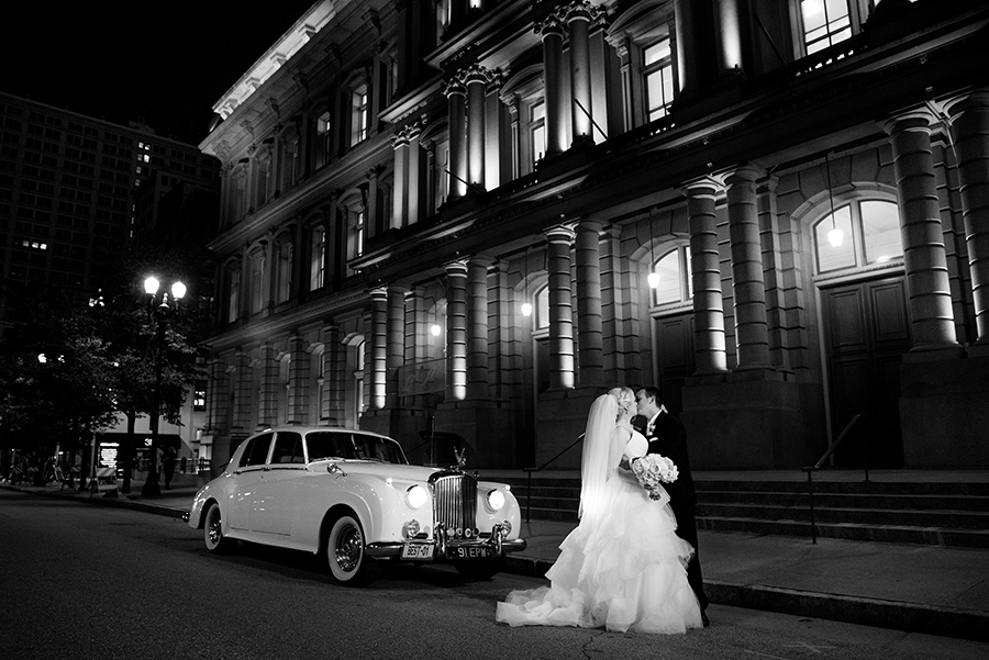 black and white photo of couple with rolls royce in front of the old post office by ashley fisher photography