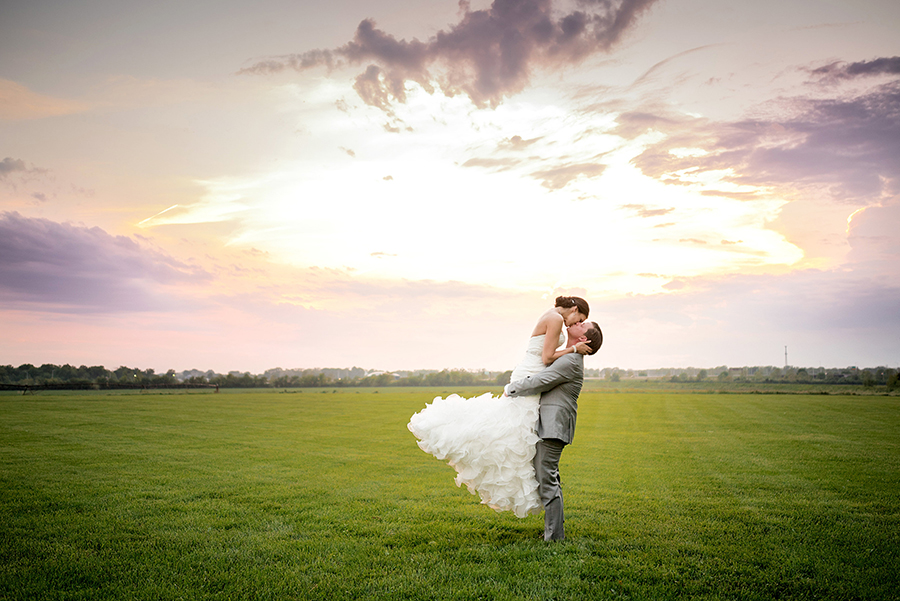 photo of couple at sunset after a storm on their wedding day by ashley fisher photography