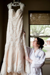 photo of bride admiring her gown by ashley fisher photography