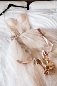 photo of bride's dress on bed by ashley fisher photography