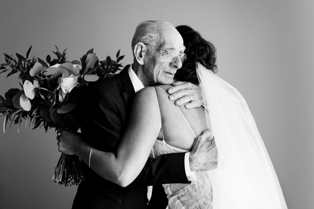 grandpa emotionally hugging bride after he saw her for the first time