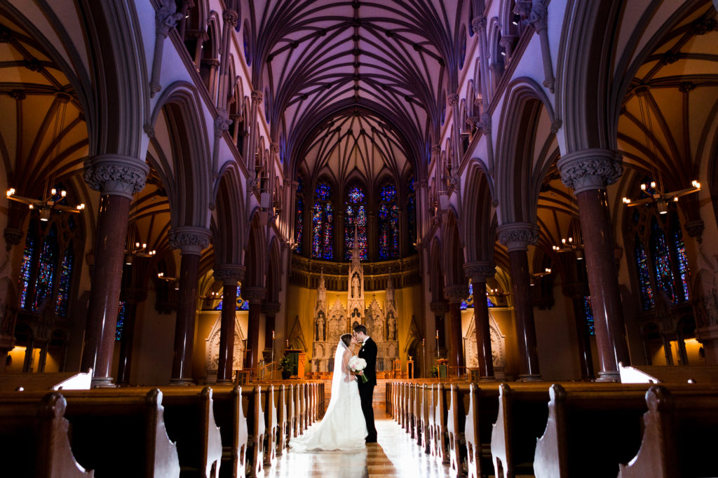 couple taking a moment post-wedding ceremony at st francis xavier college church