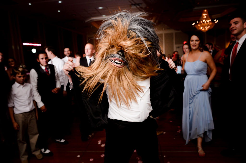 guest wearing chewbacca mask on dance floor at wedding at clayton plaza hotel