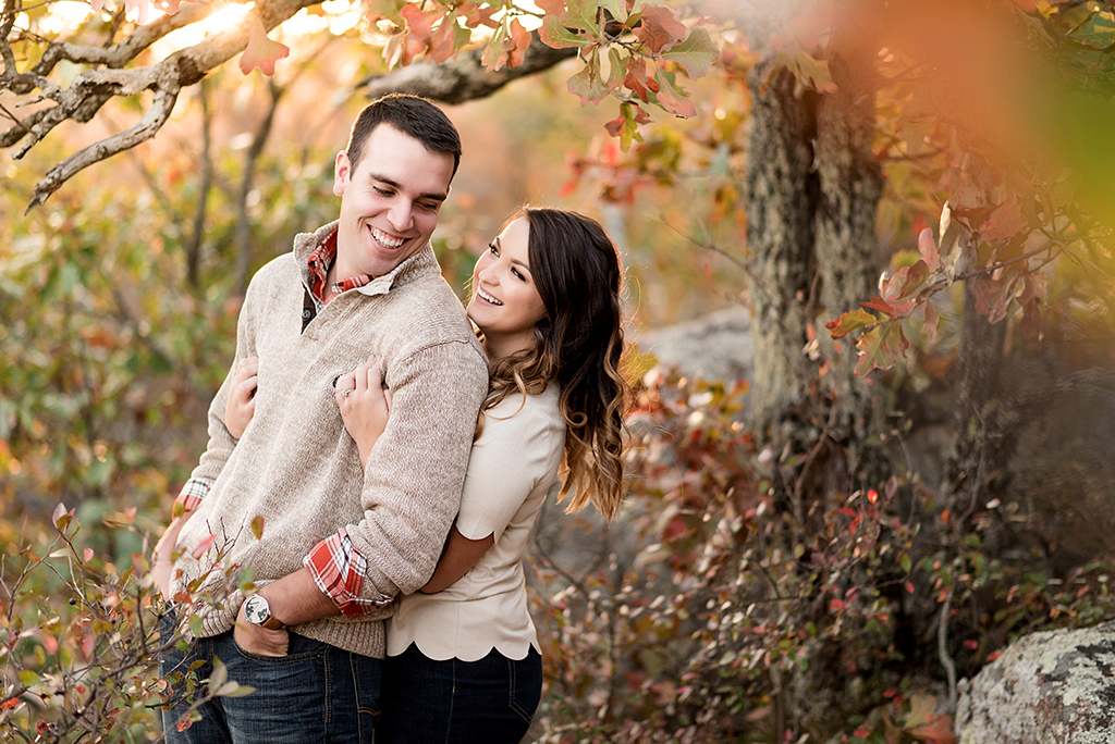couple laughing with fall color at elephant rock engagement session