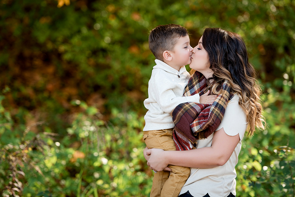 toddler son kissing mom at elephant rock