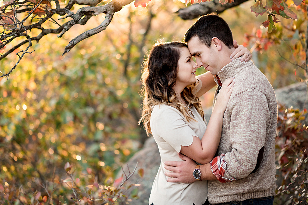 couple forehead to forehead cuddling during fall elephant rock engagement session
