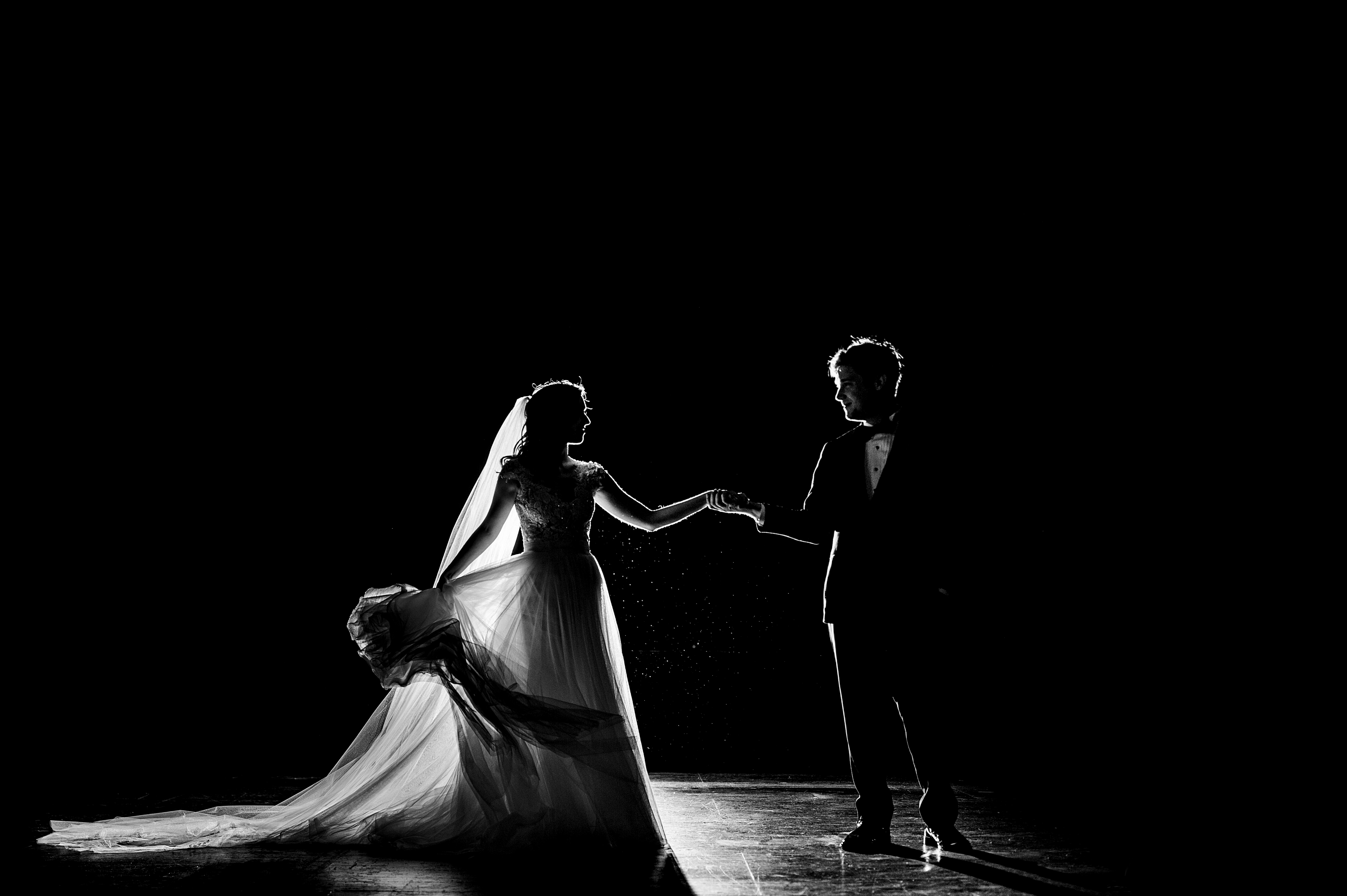 backlit bride and groom dancing on stage at stifel theater wedding